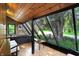 Bright sunroom with large windows, stone accent wall, and an adjacent patio at 3317 S 100 E, Greenfield, IN 46140