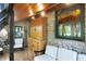 A sunroom features natural stone walls, wood accents, comfortable seating, and bright natural light at 3317 S 100 E, Greenfield, IN 46140
