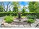 Charming tiered water fountain surrounded by vibrant plants and greenery, creating a serene backyard oasis at 3317 S 100 E, Greenfield, IN 46140