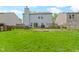 Large backyard with green grass, patio, two story house, and plenty of space for recreation at 3362 Pavetto Ln, Indianapolis, IN 46203