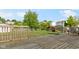 Fenced backyard features a wooden deck and a lush lawn, ideal for outdoor activities at 3362 Pavetto Ln, Indianapolis, IN 46203