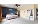 Bedroom featuring an accent wall, neutral carpeting, and a view to the ensuite bathroom at 3362 Pavetto Ln, Indianapolis, IN 46203