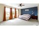 Sunny bedroom with a large window, neutral carpeting, and an accent wall at 3362 Pavetto Ln, Indianapolis, IN 46203