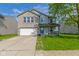Charming two-story home with a well-maintained front lawn and attached two-car garage at 3362 Pavetto Ln, Indianapolis, IN 46203