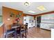 Bright kitchen with a dining area, white cabinets, and modern appliances at 3362 Pavetto Ln, Indianapolis, IN 46203