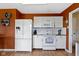 Bright kitchen features white appliances, ample cabinet space, and a contrasting burnt orange color at 3362 Pavetto Ln, Indianapolis, IN 46203