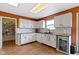 Well-lit kitchen featuring white cabinets, wood floors, and modern appliances at 3362 Pavetto Ln, Indianapolis, IN 46203