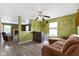 Cozy living room featuring an open layout, wood floors, and modern ceiling fan at 3362 Pavetto Ln, Indianapolis, IN 46203