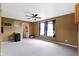 The well-lit living room offers a ceiling fan, neutral carpeting, and space for a variety of uses at 3362 Pavetto Ln, Indianapolis, IN 46203