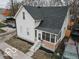 Aerial view of a two-story home with a front porch, neat landscaping, and a paved driveway at 352 W 28Th St, Indianapolis, IN 46208