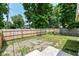 View of the backyard with wood fence, grass, some rock, and concrete patio at 352 W 28Th St, Indianapolis, IN 46208