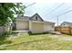 Back of house with steps to small patio and partial view of the backyard and fence at 352 W 28Th St, Indianapolis, IN 46208