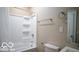 A bright bathroom featuring a shower-tub combo, toilet, and a well-lit vanity with mirror at 352 W 28Th St, Indianapolis, IN 46208