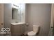 Clean bathroom featuring a gray vanity, modern fixtures, and a toilet at 352 W 28Th St, Indianapolis, IN 46208