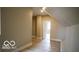 A comfortable bedroom showcasing neutral walls and light wood floors, leading to an adjacent room at 352 W 28Th St, Indianapolis, IN 46208