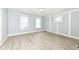 Bright bedroom with light-toned laminate flooring, neutral walls and trim, and natural light from three windows at 352 W 28Th St, Indianapolis, IN 46208