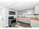 Updated kitchen featuring stainless steel appliances, gray cabinets, and wood-look countertops at 352 W 28Th St, Indianapolis, IN 46208