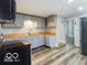 A view of the kitchen with gray cabinets, butcher block countertops, and wood-look vinyl flooring at 352 W 28Th St, Indianapolis, IN 46208