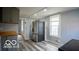 A view of the kitchen with stainless steel refrigerator and gray walls and cabinetry at 352 W 28Th St, Indianapolis, IN 46208