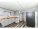 Cozy kitchen with gray cabinetry, wood-look countertops, modern appliances, and plank flooring at 352 W 28Th St, Indianapolis, IN 46208