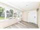 Inviting screened porch featuring light wood-look flooring, white trim and walls, and great natural light at 352 W 28Th St, Indianapolis, IN 46208