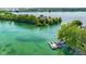 Scenic aerial view showcases home docks with boats on a pristine blue lake at 3532 Clearwater Cir, Indianapolis, IN 46240
