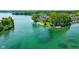 Picturesque aerial view shows lakeside property with private boat dock on a tranquil blue lake at 3532 Clearwater Cir, Indianapolis, IN 46240