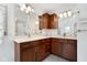 Elegant bathroom with granite countertops, custom wood cabinetry, and dual sinks at 3532 Clearwater Cir, Indianapolis, IN 46240