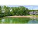 Picturesque view of a sandy beach and clear water, perfect for lakefront living at 3532 Clearwater Cir, Indianapolis, IN 46240
