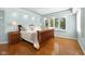 Cozy bedroom featuring hardwood floors, natural light, and tray ceilings at 3532 Clearwater Cir, Indianapolis, IN 46240