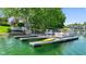 Private dock with boat slips and a bright yellow kayak on a calm lake at 3532 Clearwater Cir, Indianapolis, IN 46240