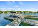 View of a private boat dock with multiple boat slips and watercraft under a clear sky at 3532 Clearwater Cir, Indianapolis, IN 46240