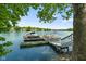 A picturesque dock on a calm lake featuring multiple boat slips and clear blue sky at 3532 Clearwater Cir, Indianapolis, IN 46240