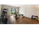 Home gym equipped with fitness equipment and sliding door leading to lake views at 3532 Clearwater Cir, Indianapolis, IN 46240