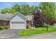 Inviting home exterior with brick details, two car garage, and manicured lawn at 3532 Clearwater Cir, Indianapolis, IN 46240