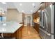 Bright kitchen featuring a large island, stainless steel appliances, and hardwood floors at 3532 Clearwater Cir, Indianapolis, IN 46240
