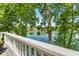 Balcony with a picturesque lake view framed by lush greenery and white railing at 3532 Clearwater Cir, Indianapolis, IN 46240