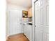 Convenient laundry area with washer, dryer, cabinet storage, and easy access to exterior at 3532 Clearwater Cir, Indianapolis, IN 46240
