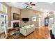 Bright living room features a fireplace, tv and open staircase at 3532 Clearwater Cir, Indianapolis, IN 46240