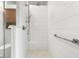 Modern shower with white tile, glass door, and sleek fixtures at 3532 Clearwater Cir, Indianapolis, IN 46240