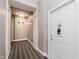 Apartment hallway featuring a striped carpet and unit door with hardware at 355 E Ohio St # 209, Indianapolis, IN 46204