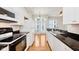 Modern kitchen with stainless steel appliances, granite countertops, and hardwood floors at 355 E Ohio St # 209, Indianapolis, IN 46204