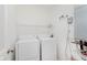A functional laundry room with washer, dryer, shelving and water heater at 355 E Ohio St # 209, Indianapolis, IN 46204