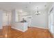 Open floorplan living area with wooden floor, dining area, and a view of the kitchen at 355 E Ohio St # 209, Indianapolis, IN 46204