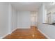 Living room featuring wood floors, grey walls, and an entry door at 355 E Ohio St # 209, Indianapolis, IN 46204