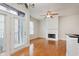 Living room featuring a fireplace, wooden floors, ceiling fan, and double doors at 355 E Ohio St # 209, Indianapolis, IN 46204