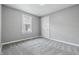 Clean and minimalist bedroom with neutral colors and a window at 3906 Fletcher Ave, Indianapolis, IN 46203