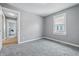A bedroom leading into another room, featuring neutral colors and a window at 3906 Fletcher Ave, Indianapolis, IN 46203