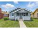 Charming bungalow featuring a cozy front porch, landscaped yard, and well-maintained exterior in a residential neighborhood at 3906 Fletcher Ave, Indianapolis, IN 46203