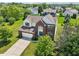Aerial view of home showcasing its brick facade, manicured lawn, and landscaping at 4017 Ivory Ct, Carmel, IN 46074